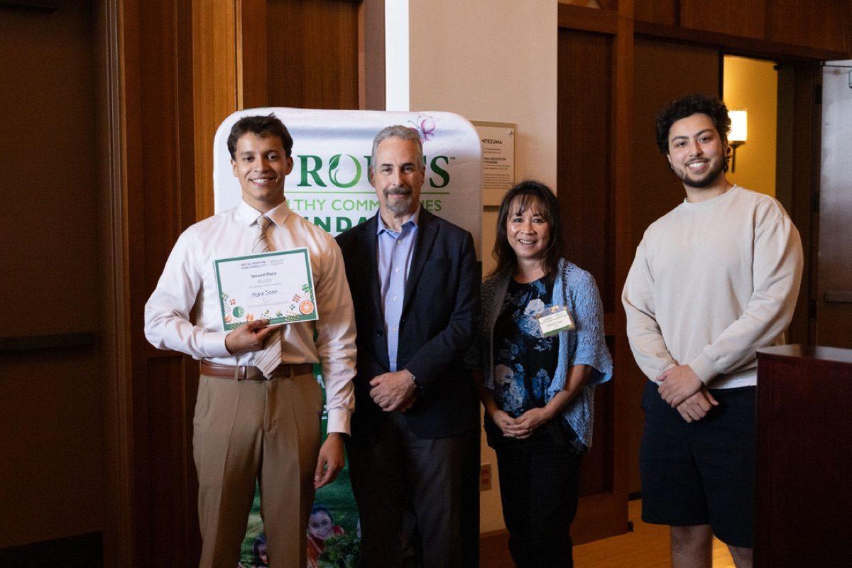 Christopher Carrillo holding the second-place certificate at the SDSU Social Venture Challenge