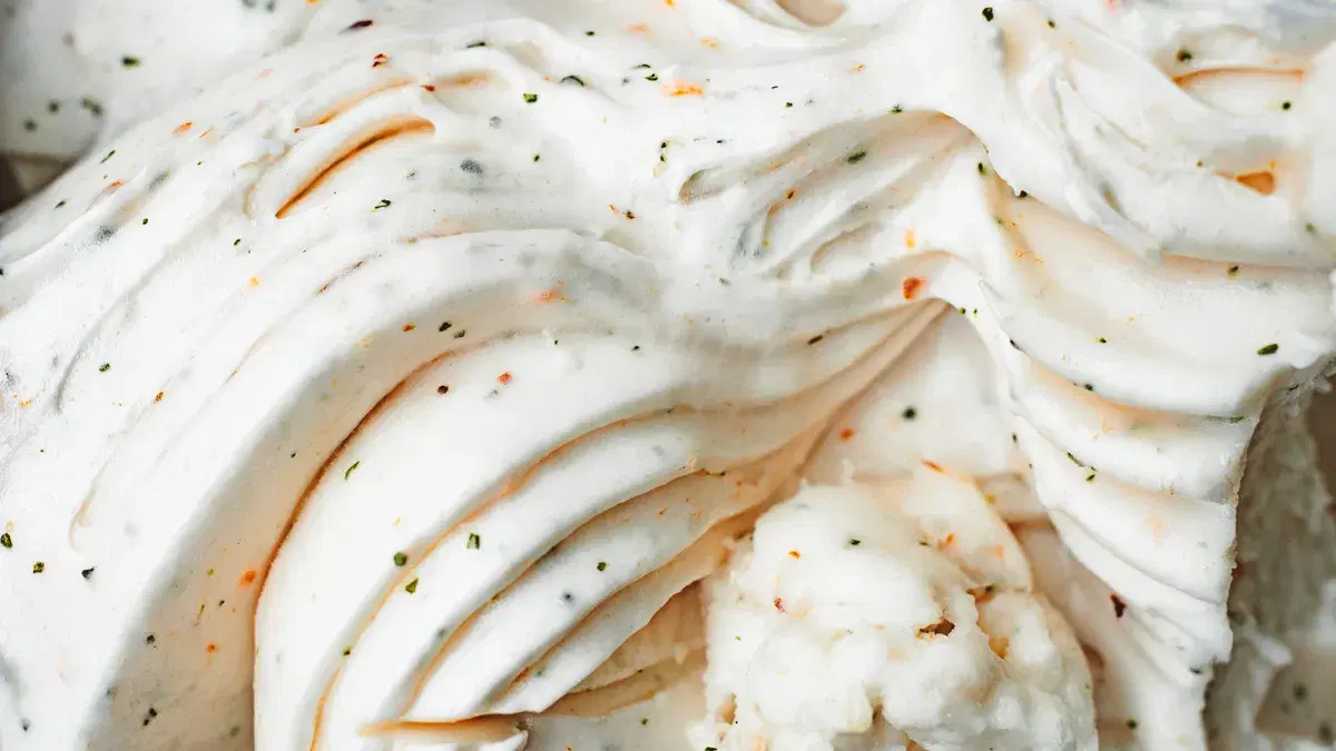 Delicious creamy vanilla ice cream with textured swirls and flecks, captured in a close-up view.