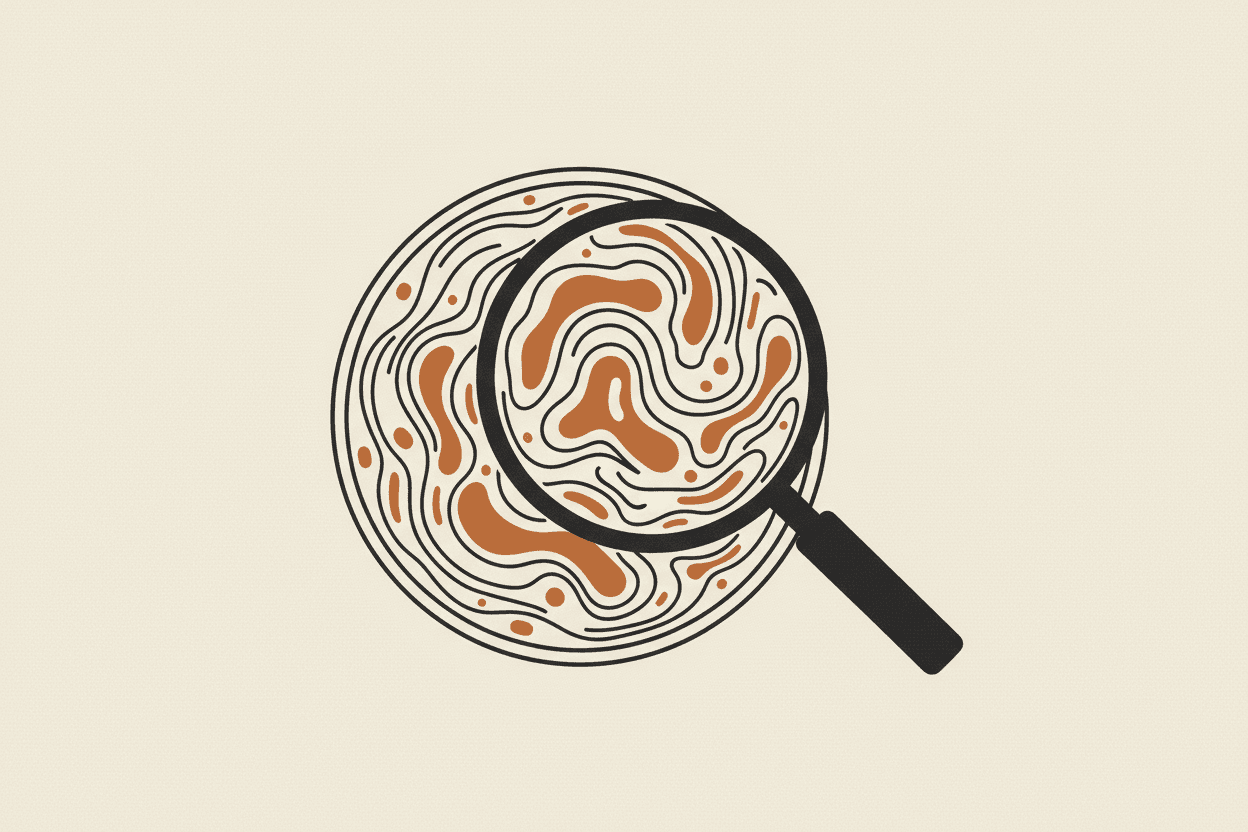 Illustration of a petri dish with a swirling liquid and a magnifying glass