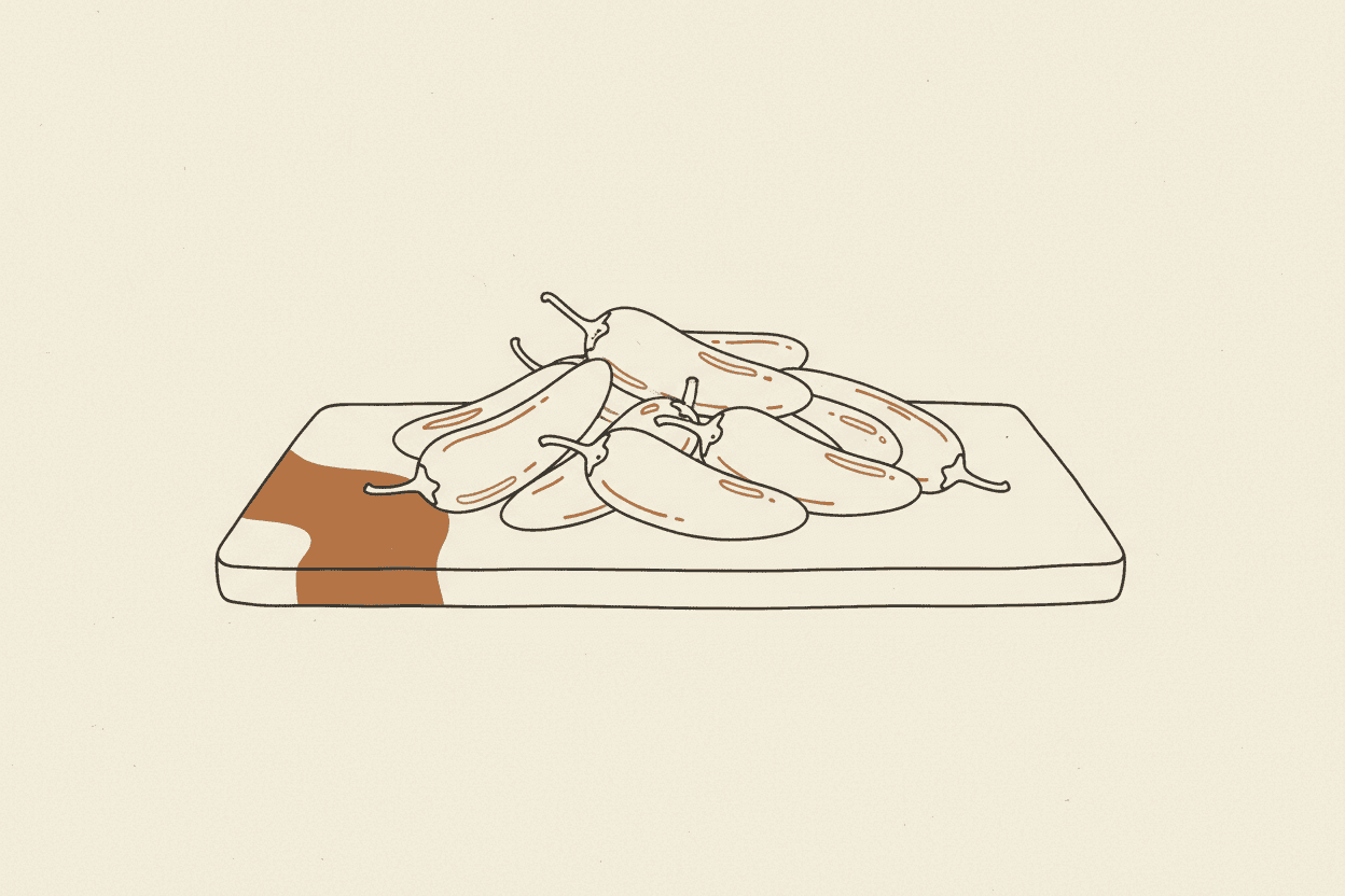 Illustration of a pile of fresh jalapeño peppers on a wooden cutting board